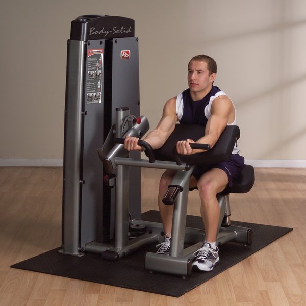 Athlete performing a bicep curl on the Body-Solid Pro Dual Bicep/Tricep Machine DBTC-SF