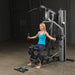 Female athlete performing chest fly on Body-Solid G5S Home Gym with arms extended outward