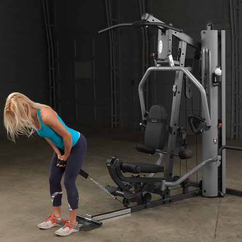 Female athlete executing standing hip thrust on Body-Solid G5S Home Gym with cable resistance.