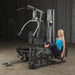 Female athlete using optional leg press attachment on Body-Solid G5S Home Gym for lower body workout.