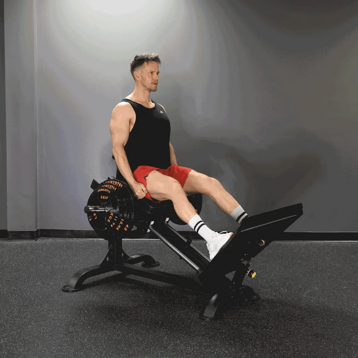 Video demonstration of the Powertec Compact Leg Sled P-CLS23 showcasing all adjustable settings, including backrest, footplate, safety lock positions, and range limiter peg, with an athlete performing leg presses at various positions.