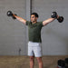 Person performing a lateral raise with Body-Solid Tools SDBX132 Adjustable Dumbbells, lifting the dumbbells to shoulder height with arms slightly bent.