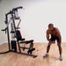 Black male performing a one-arm bent-over row using the low row cable with a single handle cable attachment on the Body-Solid G3S Home Gym."